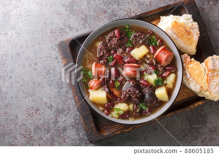 Sopa de pedra Portuguese Stone Soup combination of beans and sausages such as chorizo and morcilla close up in the plate. Horizontal top view 88605185