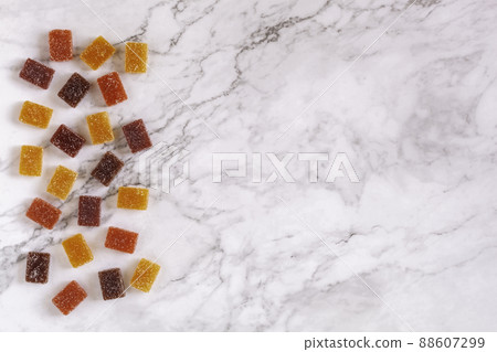 Different tastes of fruit paste on marble background, top view, copy space 88607299