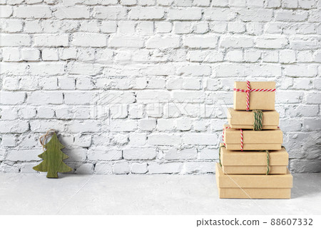 Craft paper gift boxes, form of New Year tree with a small wooden Christmas tree Craft paper gift boxes, form of New Year tree with a small wooden Christmas tree 88607332