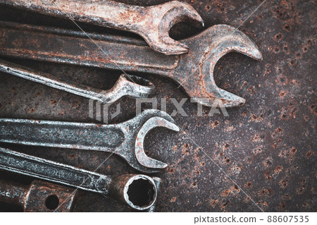 Old wrenches tools on rusty metal table Old wrenches tools on rusty metal table 88607535