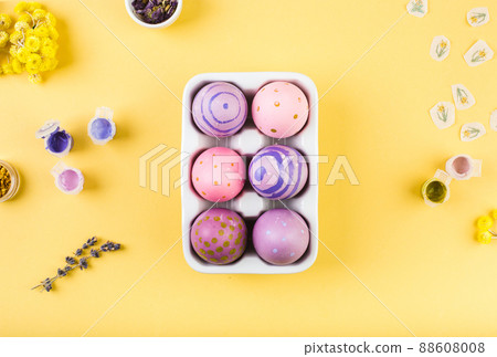 Easter decorated eggs on yellow background. Minimal happy easter concept. Top view. Easter decorated eggs on yellow background. Minimal happy easter concept. Top view. 88608008