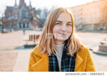 happy smiling young woman on sunny city street 88608025