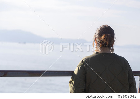 A woman looking at the sea A woman looking at the sea 88608042