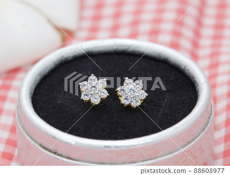Beautiful diamond earrings in flower shape display in jewelry box 88608977