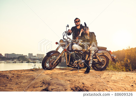 Sexy couple of bikers on the vintage custom motorcycle, girl in a rabbit mask Sexy couple of bikers on the vintage custom motorcycle, girl in a rabbit mask 88609326