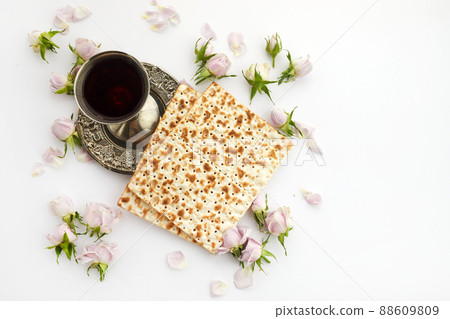 Pesah celebration concept, jewish Passover holiday. Matzah and red kosher. Traditional ritual Jewish bread on white background Pesah celebration concept, jewish Passover holiday. Matzah and red kosher. Traditional ritual Jewish bread on white background 88609809