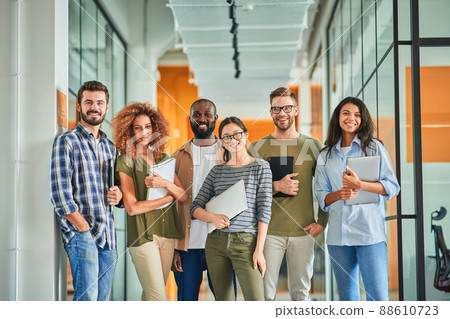 Group of self-assured young coworkers posing for team photo Group of self-assured young coworkers posing for team photo 88610723
