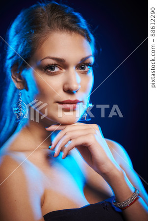 Young beautiful woman with blue side light Young beautiful woman with blue side light 88612290