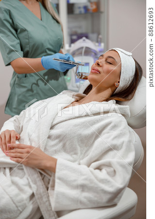 Cosmetologist making aesthetic face treatment in beauty salon. Rejuvenation and hydration 88612693