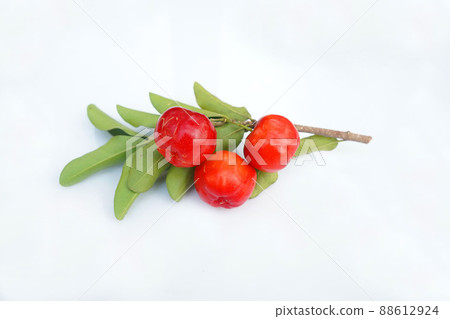 Acerola Cherry with half slice and green leaves isolated on white background Acerola Cherry with half slice and green leaves isolated on white background 88612924