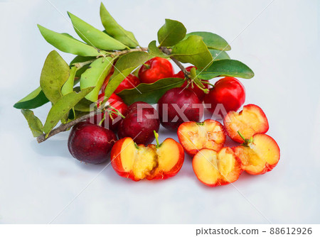 Acerola Cherry with half slice and green leaves isolated on white background Acerola Cherry with half slice and green leaves isolated on white background 88612926