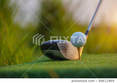 Golf club and ball on green grass ready to be struck on golf course background Golf club and ball on green grass ready to be struck on golf course background 88612969