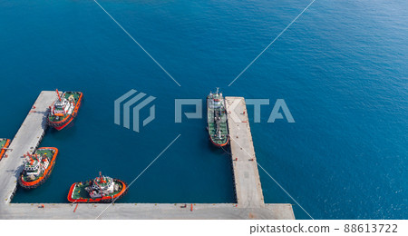 Tug boats and tanker vessel are moored in port. Aerial view. Jedda port Tug boats and tanker vessel are moored in port. Aerial view. Jedda port 88613722