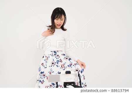 Woman in fashion pose in front of camera Woman in fashion pose in front of camera 88613794