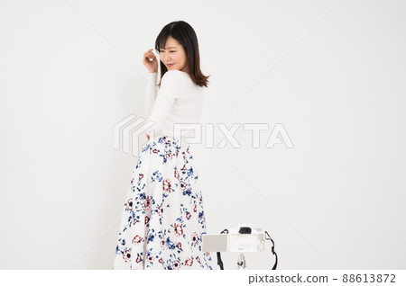 Woman in fashion pose in front of camera Woman in fashion pose in front of camera 88613872