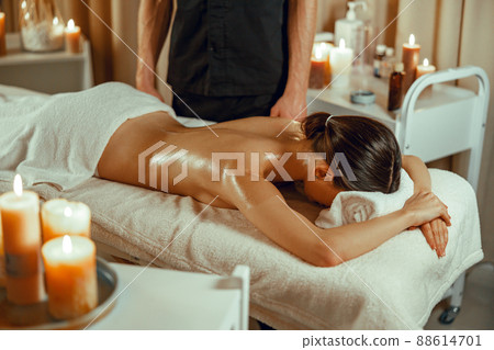 Half naked relaxed woman ready for back massage at beauty spa resort 88614701