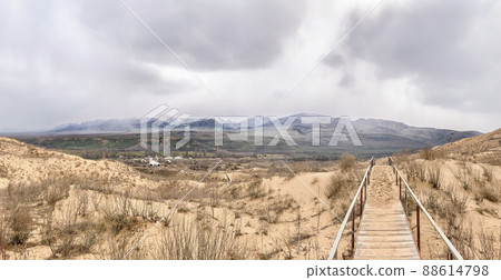 The staircase rises to a sandy dune. Climbing to the top in the desert The staircase rises to a sandy dune. Climbing to the top in the desert 88614798
