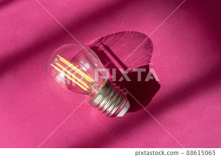 Light bulb on purple background with shadows close up. Creative new idea, innovation, inspiration concept. 88615065