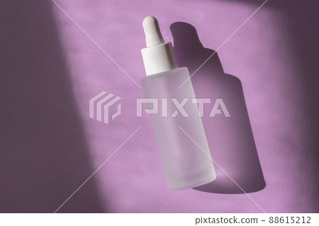 Cosmetic liquid mockup in transparent bottle on pastel lilac background, top view. Hyaluronic acid oil, serum with collagen skin care product 88615212