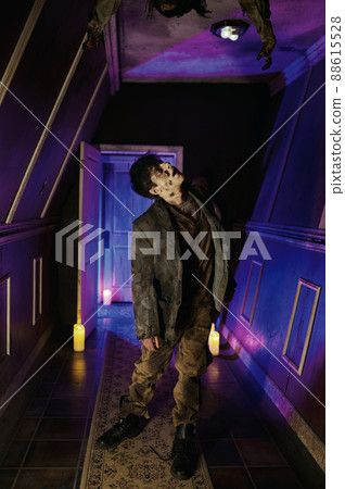Zombie in neon illuminated horror house hall 88615528