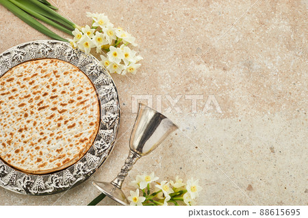 Pesah celebration concept, jewish Passover holiday. Matzah and red kosher. Traditional ritual Jewish bread on travertine stone background Pesah celebration concept, jewish Passover holiday. Matzah and red kosher. Traditional ritual Jewish bread on travertine stone background 88615695