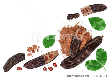 Ripe carob pods and bean isolated on white background. Top view with copy space for your text. Flat lay 88616121