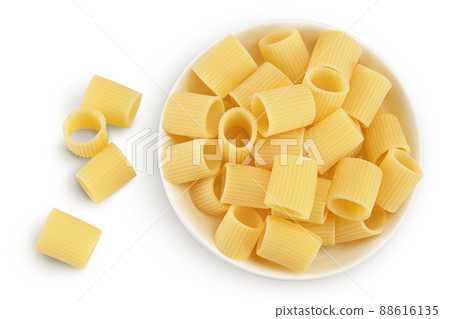 raw italian pasta in ceramic bowl isolated on white background with clipping path . Mezze Maniche Rigate Bronze die. Top view. Flat lay 88616135