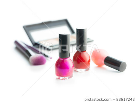 Set of cosmetic makeup products. Eyeshadow, nail polish and makeup brushes isolated on white background. Set of cosmetic makeup products. Eyeshadow, nail polish and makeup brushes isolated on white background. 88617248
