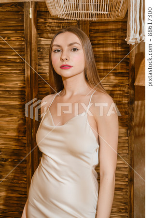 Gorgeous young woman in spaghetti strap dress 88617300