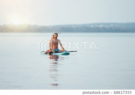 young couple in love walking sitting on the SAP board . young couple in love walking sitting on the SAP board . 88617355