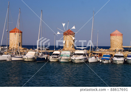 Historic windmills and boats on the sea Historic windmills and boats on the sea 88617691