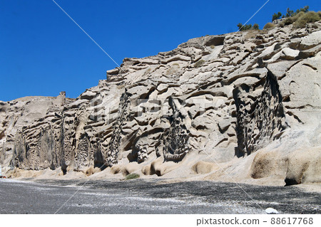 Layered brown cliff and rocks Layered brown cliff and rocks 88617768