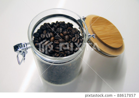 Close up of a isolated glass and wood coffee jar Close up of a isolated glass and wood coffee jar 88617857