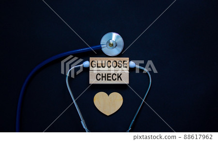 Wooden blocks with words 'clucose check' and stethoscope on black background. Wooden heart. Medical concept. 88617962