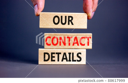 Our contact details symbol. Concept words Our contact details on wooden blocks. Businessman hand. Beautiful grey table grey background. Business our contact details concept. Copy space. 88617999