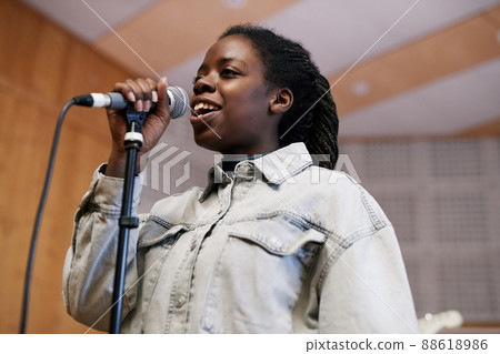 Young Woman Singing in Recording Studio Young Woman Singing in Recording Studio 88618986
