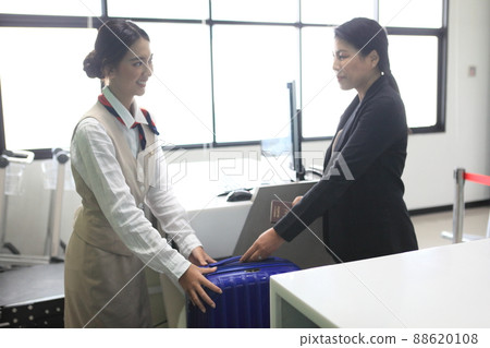 checking bag airport , Luggage weighting at check-in desk at Asia airport checking bag airport , Luggage weighting at check-in desk at Asia airport 88620108