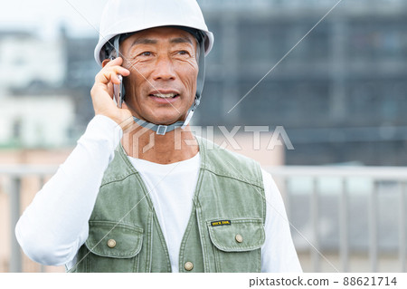 Middle male worker working at a construction site Middle male worker working at a construction site 88621714