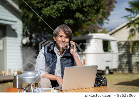 Middle-aged man using a computer outdoors 88622866