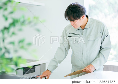 A man in the kitchen and work clothes (dishwasher) A man in the kitchen and work clothes (dishwasher) 88624127