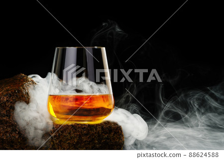 Wisky glass on the rock on black background. Wisky glass without ice Wisky glass on the rock on black background. Wisky glass without ice 88624588