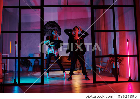 Couple of teenage dancers in posh apparel performing vogue dance movements 88624899