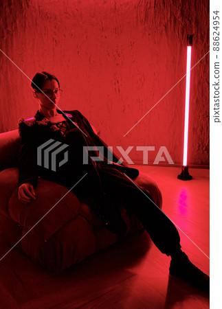 Young restful posh man or teenage guy in smart suit relaxing in armchair in club 88624954