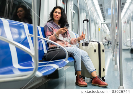 Woman passenger using phone in subway car 88626744
