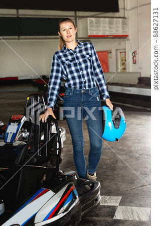 Portrait of glad woman holding helmet 88627131