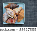 Variety of croissants and macarons 88627555