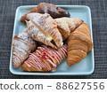 Variety of croissants and macarons 88627556