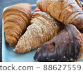 Variety of croissants and macarons 88627559