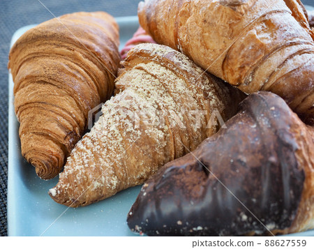 Variety of croissants and macarons Variety of croissants and macarons 88627559