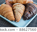 Variety of croissants and macarons 88627560